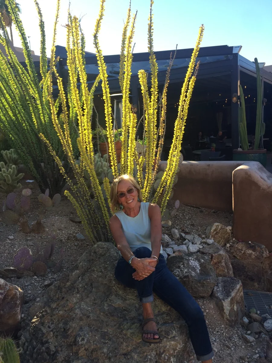 Meredith Davis seated outdoors in a desert garden